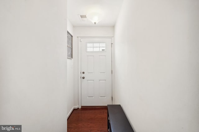 doorway with visible vents and dark wood-type flooring
