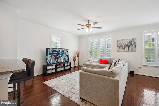 living room featuring dark wood-type flooring, a ceiling fan, and a wealth of natural light
