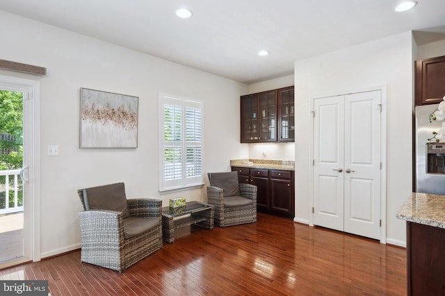 sitting room with recessed lighting, plenty of natural light, and dark wood-style floors