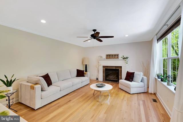 living area featuring recessed lighting, ceiling fan, visible vents, and wood finished floors