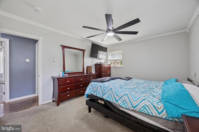 bedroom featuring crown molding, a ceiling fan, baseboards, and carpet floors