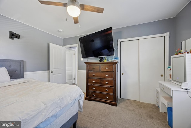 bedroom with carpet floors, a ceiling fan, and a closet