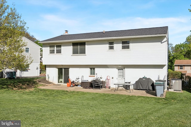 back of property featuring a yard and a patio area