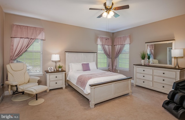 bedroom featuring a ceiling fan and light colored carpet