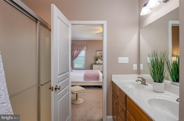 ensuite bathroom featuring double vanity, a sink, ensuite bathroom, and a stall shower
