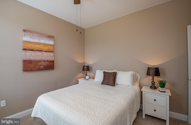 bedroom with baseboards and carpet flooring