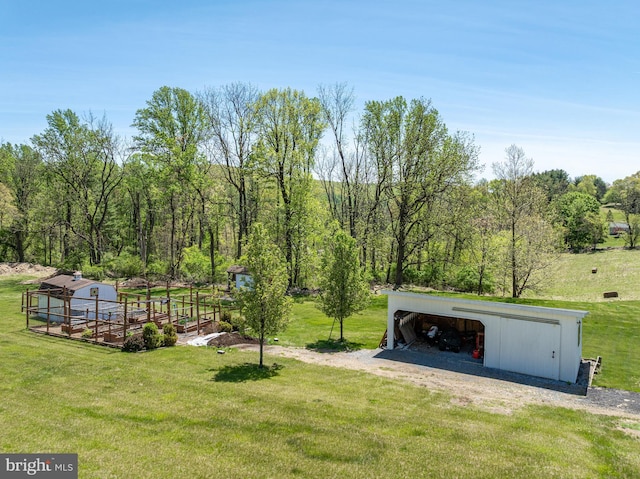 view of yard with an outbuilding, an outdoor structure, and a carport