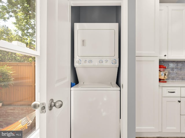 laundry area featuring laundry area and stacked washer and dryer