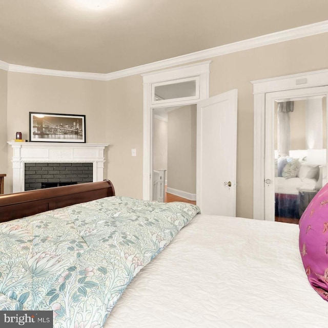 bedroom featuring crown molding and a fireplace