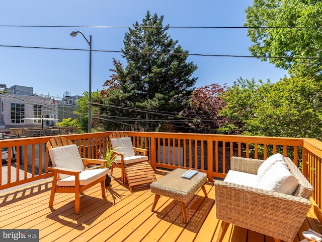 wooden terrace featuring an outdoor hangout area