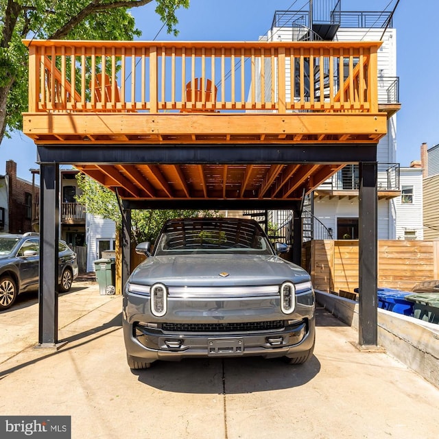 view of parking / parking lot featuring stairs and a carport