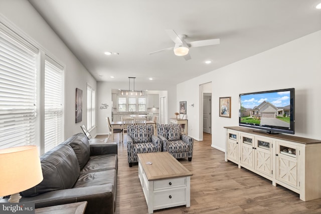 living room featuring recessed lighting, baseboards, ceiling fan, and wood finished floors