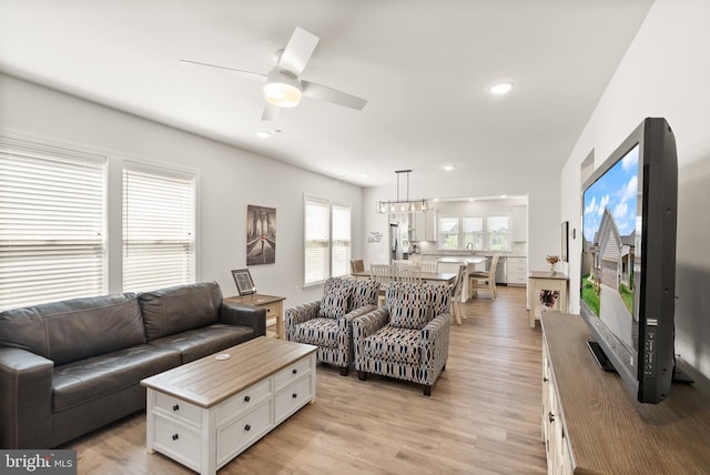 living area with recessed lighting, ceiling fan, and light wood finished floors