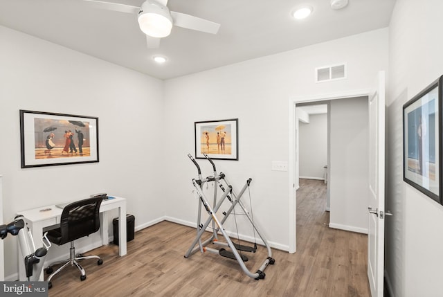 office space featuring light wood-style floors, a ceiling fan, baseboards, recessed lighting, and visible vents