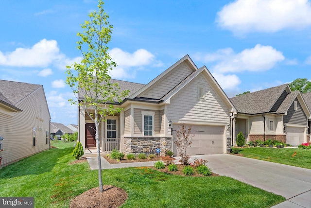craftsman-style home with driveway, roof with shingles, a front lawn, an attached garage, and stone siding