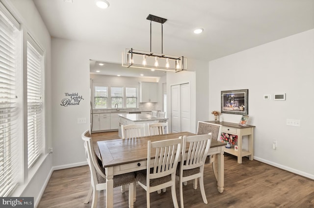 dining area featuring recessed lighting, baseboards, and light wood-type flooring