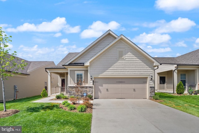 craftsman inspired home featuring a garage, a front lawn, a porch, and driveway
