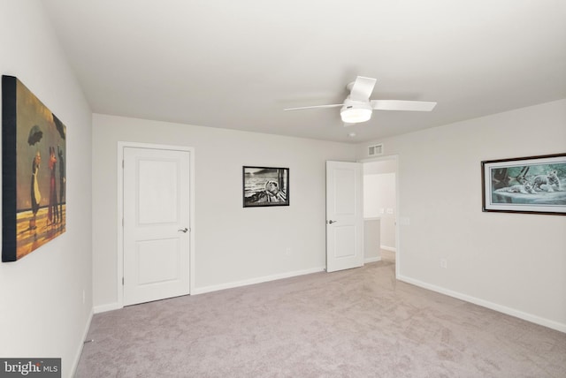 unfurnished bedroom with baseboards, a ceiling fan, carpet flooring, and visible vents