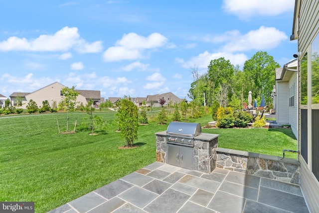 view of patio with grilling area, area for grilling, and a residential view