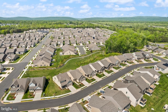 birds eye view of property featuring a view of trees and a residential view
