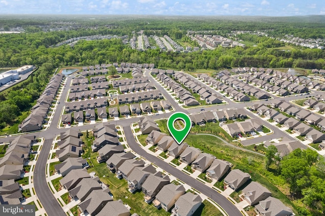 birds eye view of property with a residential view and a forest view