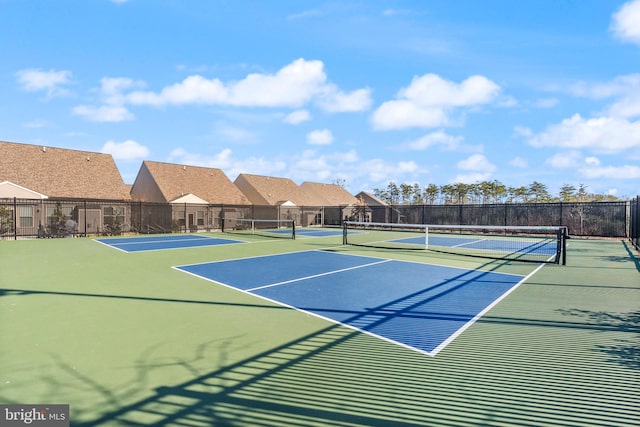 view of sport court featuring fence