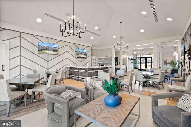 living room with recessed lighting, light wood-style flooring, a notable chandelier, and visible vents