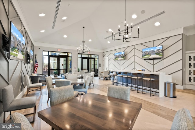 dining room featuring recessed lighting, a decorative wall, a notable chandelier, and high vaulted ceiling