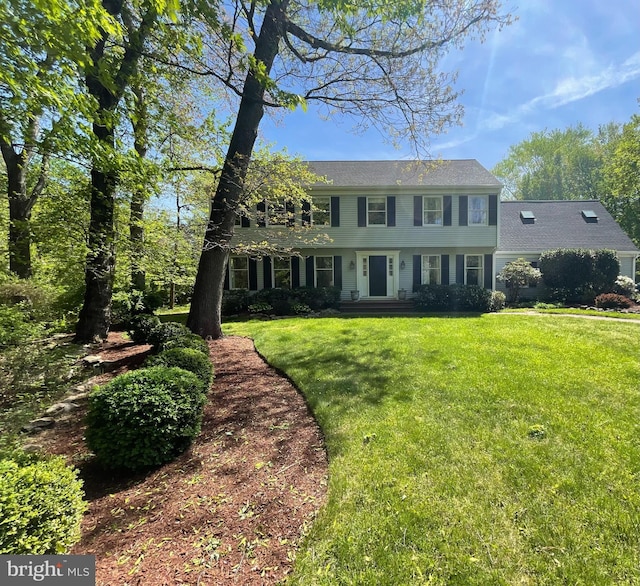 colonial-style house with a front yard