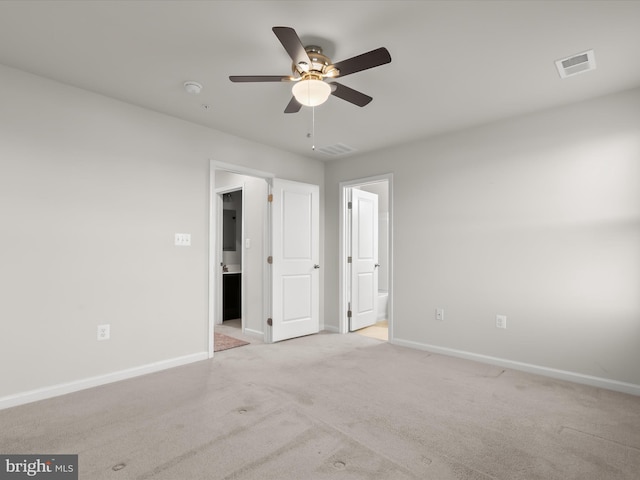 unfurnished bedroom featuring baseboards, carpet, and visible vents