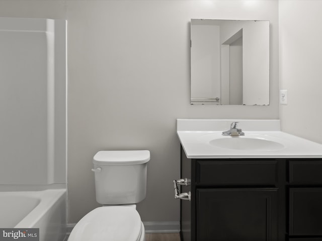 full bath with a tub, vanity, and toilet