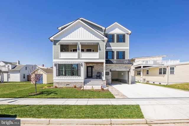 view of front of property with an attached garage, a front lawn, board and batten siding, a balcony, and driveway