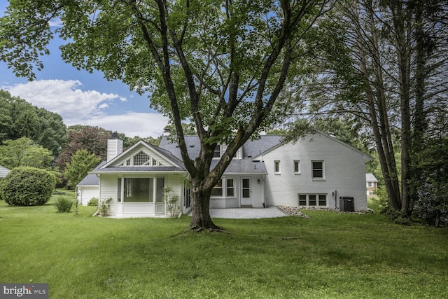 12405 Ellen Ct, Silver Spring, MD 20904 - back of house featuring central AC, a patio area, a lawn, and a chimney