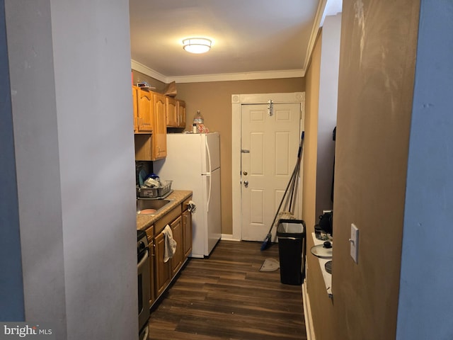 507 N Schroeder St, Baltimore, MD 21223 - kitchen with crown molding, dark wood-type flooring, freestanding refrigerator, stainless steel range, and baseboards