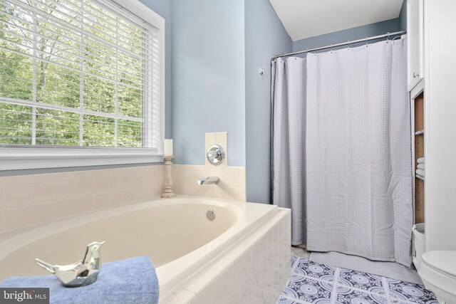 full bath featuring a shower with curtain, tile patterned flooring, a garden tub, and toilet