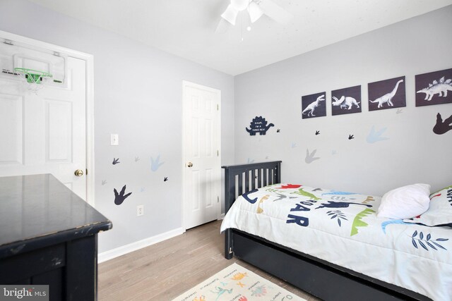 bedroom featuring light wood-style floors, baseboards, and ceiling fan