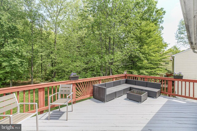 wooden terrace with outdoor lounge area