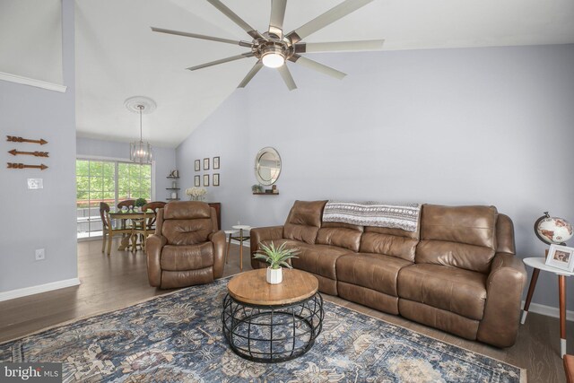 living room featuring baseboards, ceiling fan with notable chandelier, high vaulted ceiling, and wood finished floors