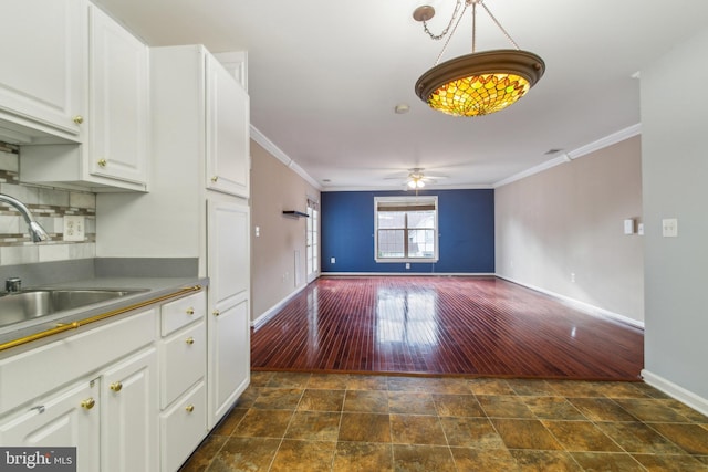 2013 Rudy Serra Dr Unit 2D, Eldersburg, MD 21784 - kitchen featuring baseboards, ornamental molding, a ceiling fan, dark wood-style floors, and white cabinets