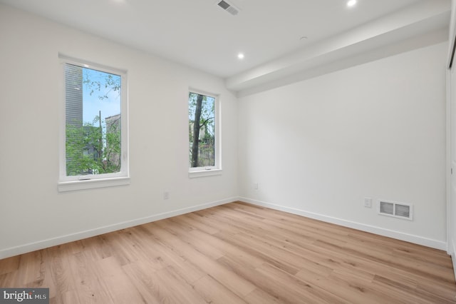 spare room featuring baseboards, recessed lighting, light wood-style flooring, and visible vents