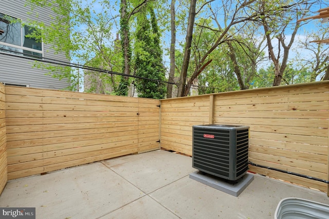 view of patio with fence and cooling unit