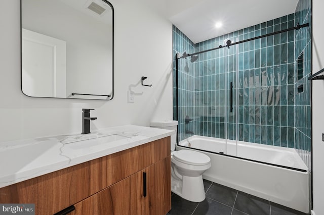 full bathroom featuring visible vents, vanity, tile patterned floors, combined bath / shower with glass door, and toilet