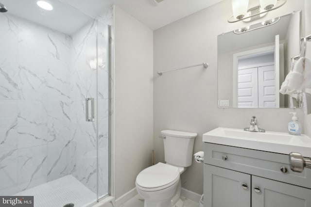 full bath featuring a marble finish shower, baseboards, vanity, and toilet