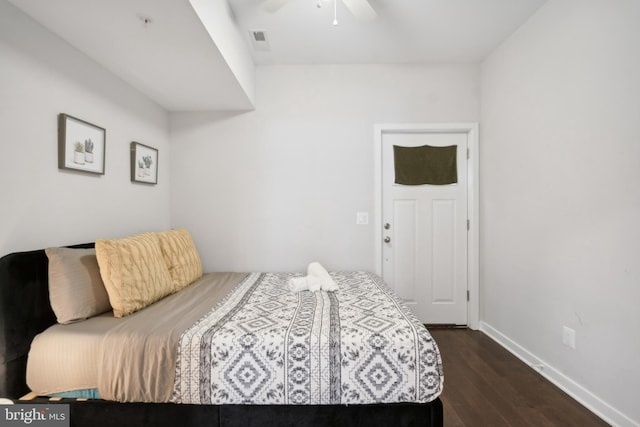 bedroom with baseboards, a ceiling fan, dark wood finished floors, and visible vents