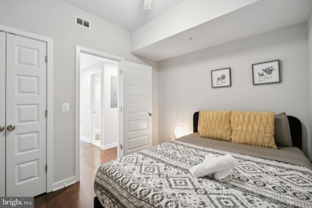 bedroom with visible vents, baseboards, and dark wood-style floors