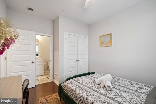 bedroom with ceiling fan, dark wood finished floors, ensuite bathroom, visible vents, and a closet
