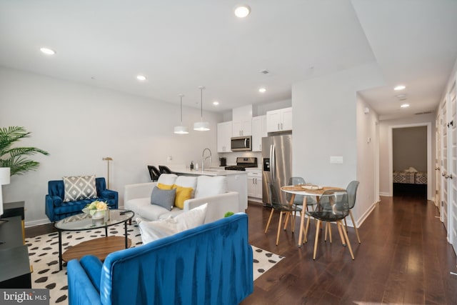 living room featuring baseboards, recessed lighting, and dark wood-type flooring