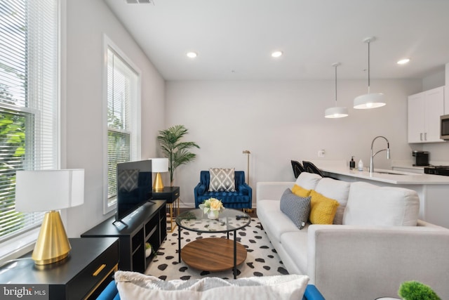 living area featuring recessed lighting and visible vents