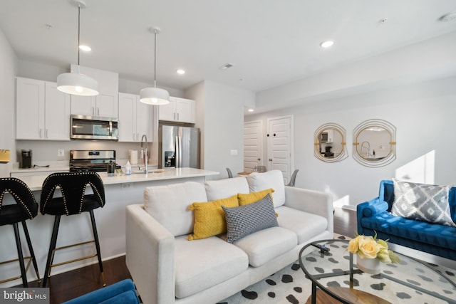 living room featuring recessed lighting and dark wood-type flooring