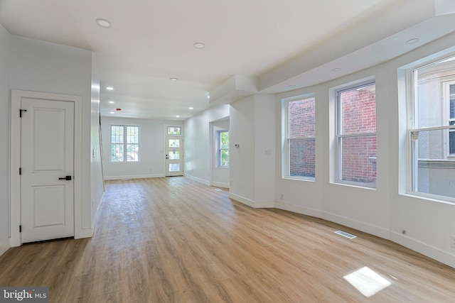 unfurnished living room featuring recessed lighting, baseboards, visible vents, and light wood-style floors